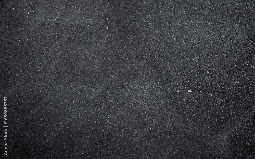 Fototapeta premium Dark or black concrete surface with distinct textures and patterns enhances visual appeal. Background