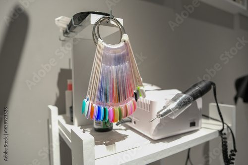 Colorful artificial nail tips for design and manicure on ring. Nail art samples for client choosing color and pattern for beauty shop.