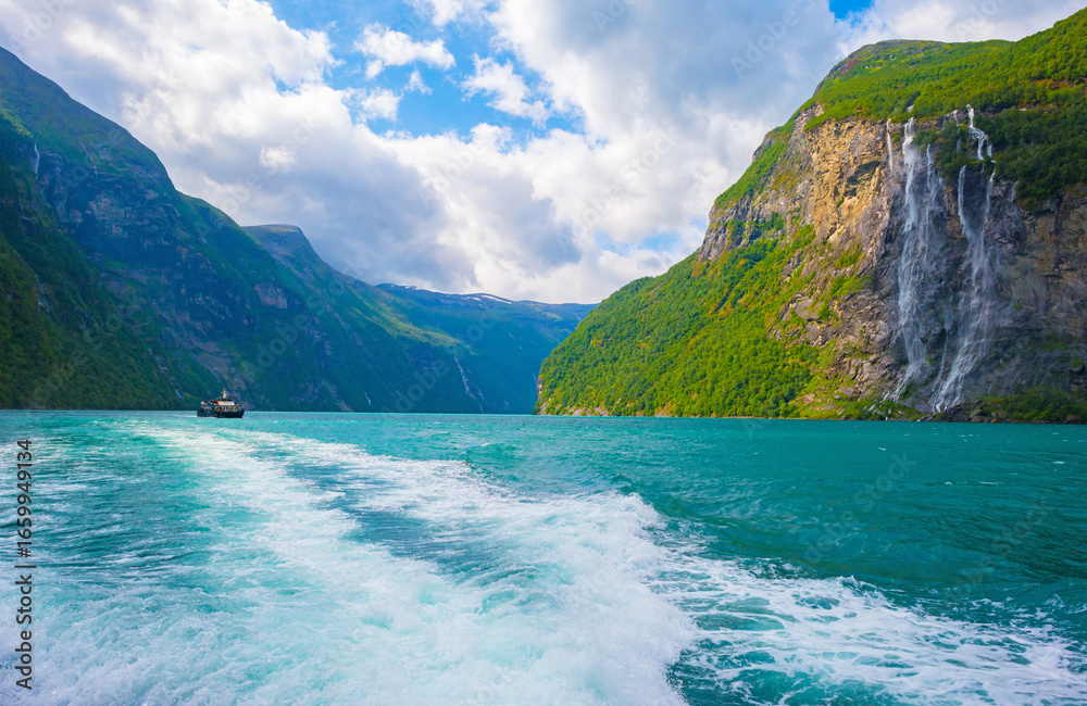 Obraz premium Waterfall falling from a mountain in a fjord in Jotunheimen National Park in Norway, August 6, 2025