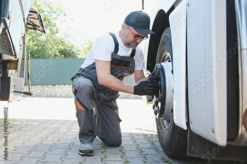 Slika na platnu Caucasian Professional Truck Mechanic Rebuilding Heavy Duty Truck Diesel Engine