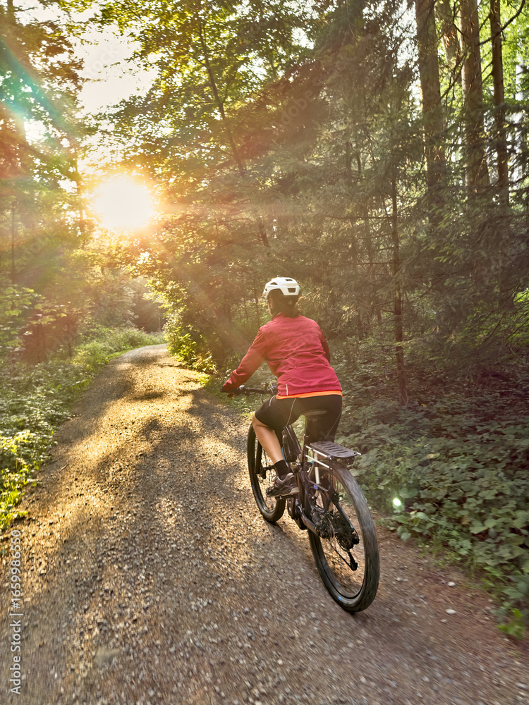 Naklejka premium nice senior woman cycling and having fun in the Allgaeu Alps near Oberstaufen, Bavaria, Germany
