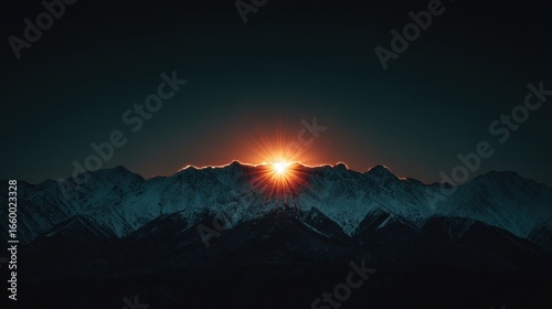A beautiful sunrise bathes snow-covered peaks in warm light, heralding a new day