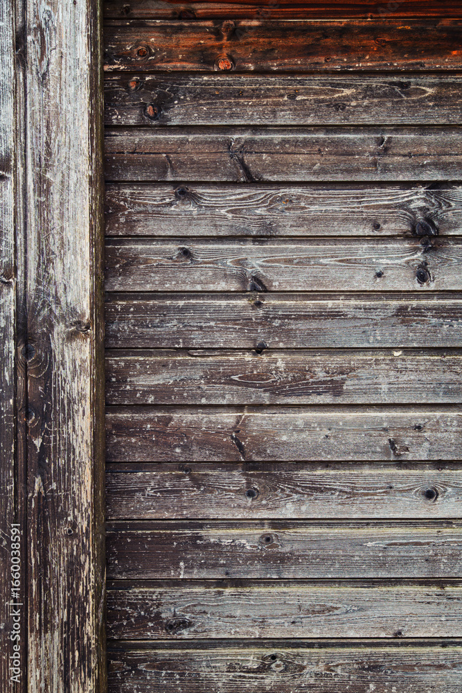 Obraz premium background of old weathered and cracked boards with peeling paint of brown color