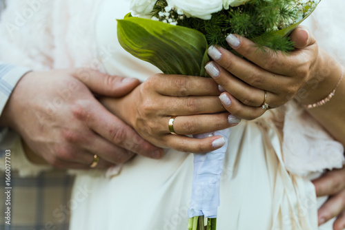 Hands of newlyweds with wedding rings, close-up.