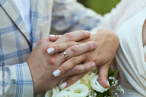 Hands of newlyweds with wedding rings, close-up.