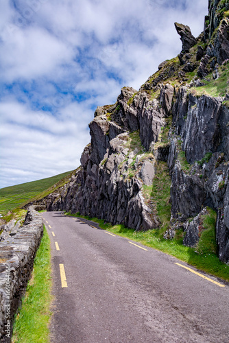 the road to the mountain by atlantic ocean shore at dingle peninsula, ireland