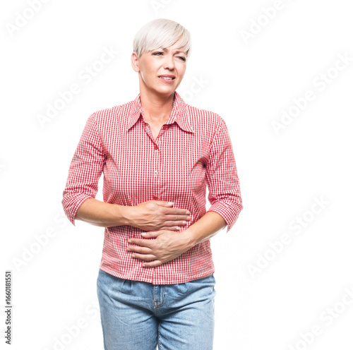 Stomach ache, woman suffering from stomachache, isolated on white background. Ill middle aged woman with chronic gastritis. Abdomen bloating concept.