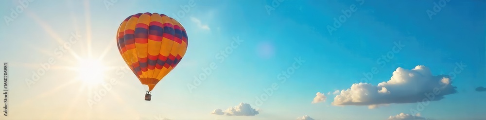 Naklejka premium Vibrant Hot Air Balloon Ascending into a Sun-Drenched Azure Sky A Stunning Image of Tranquility, Freedom, and Summer Adventure