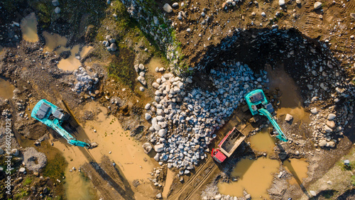 Billede på lærred Excavator and dump truck working in rock and sand mine, Construction and mining site view from above