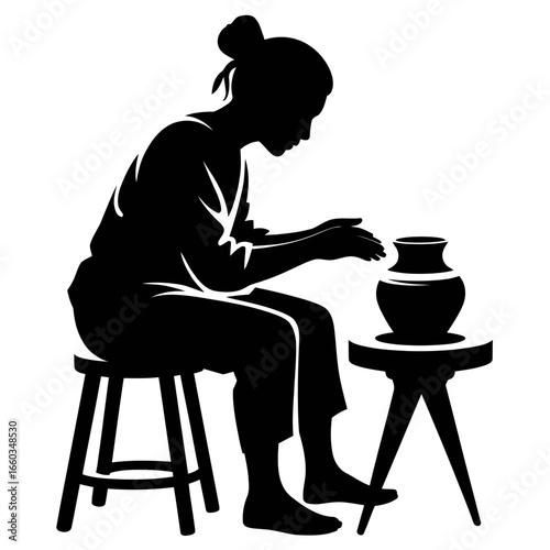 Silhouette of woman shaping clay on pottery wheel