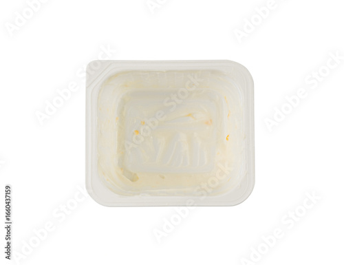 Empty yogurt cup isolated, yoghurt with orange fruits pieces in plastic pot, milk pudding container