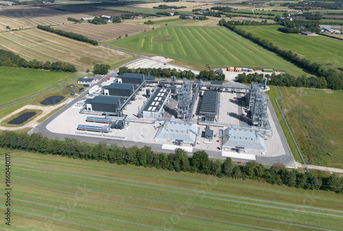 Aerial view of European Energy’s PTX facility in Kassø, Denmark. The industrial plant is surrounded by lush farmland and green fields, highlighting the integration of renewable energy infrastructure
