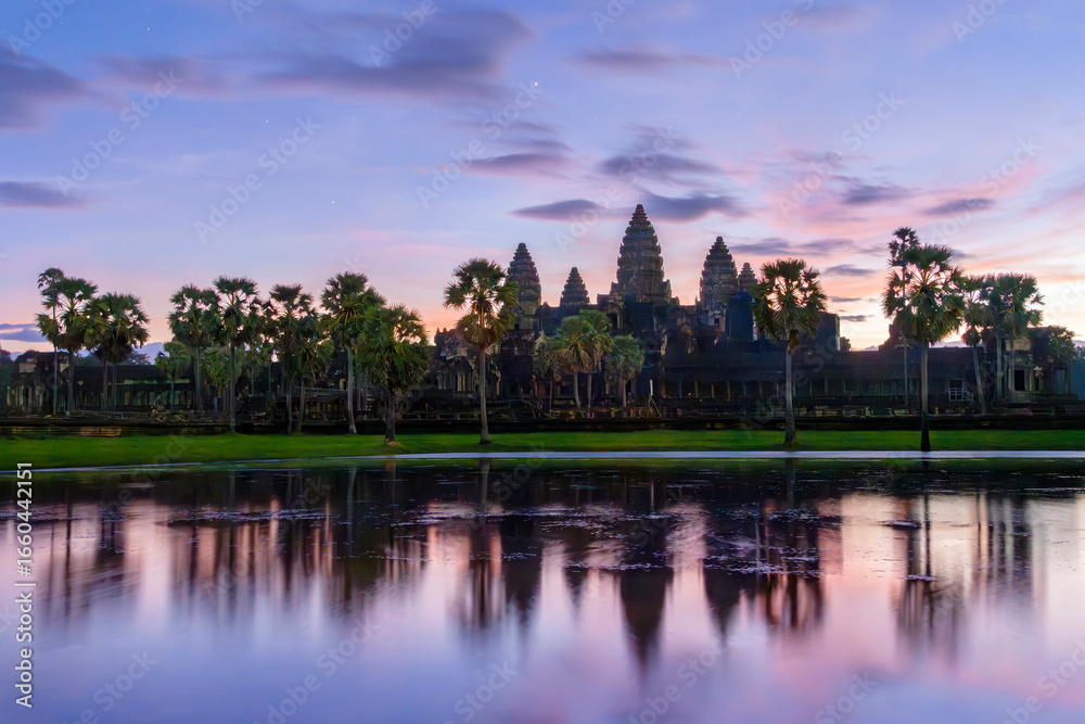 Fototapeta premium Angkor Wat temple complex at the sunrise with its reflection in water, in Siem Reap, Cambodia