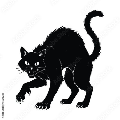 A cute young black kitten with a white nose sits looking at the camera against a white background for Halloween