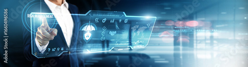 Businessman touching risk management on digital screen. threat analysis, compliance tracking, financial safeguards, operational resilience, predictive modeling, business continuity, risk mitigation