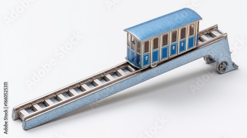 Detailed Miniature Blue And Silver Model Funicular Train On An Inclined Track Against A White Background