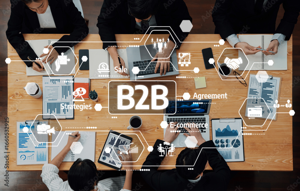 Obraz premium A dynamic business team collaborates in a modern meeting room, focusing on B2B strategies with charts and digital tools, enhancing productivity and decision-making. Amity