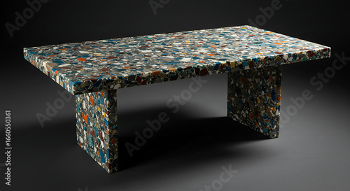A piece of furniture (table) made from recycled plastic with a terrazzo-like finish.
