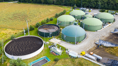 Biogas plant and farm in green fields. Renewable energy from biomass. Modern agriculture in Czech Republic and European Union.	
