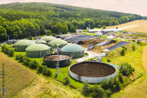 Biogas plant and farm in green fields. Renewable energy from biomass. Modern agriculture in Czech Republic and European Union.	
