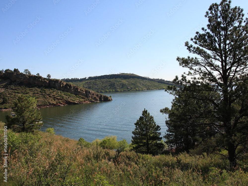 Fototapeta premium Mountain Lake Surrounded by Pine Trees