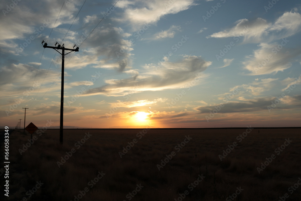Obraz premium Cloudy sky on the background of sunset. The electric transmission line is visible on the left in the photo