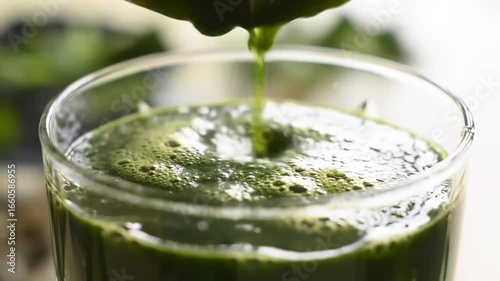 Pouring Fresh Green Juice Into Glass For Healthy Lifestyle Concept
