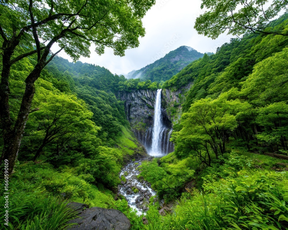 Fototapeta premium Lush waterfall cascading through green mountains