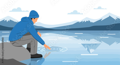 Man Reaches For Water In The Lake With Mountain Views In Background