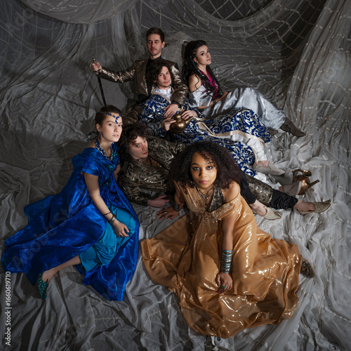 A group portrait in the style of oriental fairy tales, young men and women in oriental costumes. Arabic or Turkish style, costume photography