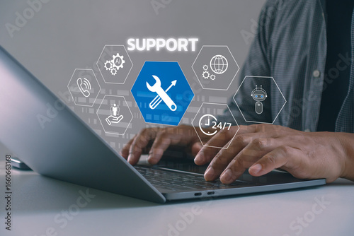 Close-up of hands typing on laptop with virtual support icons, AI tools, chatbot and 24/7 service. Concept of customer support, digital technical assistance and remote help via modern technology.