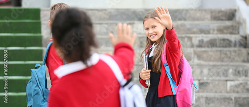 Group of happy pupils meeti...