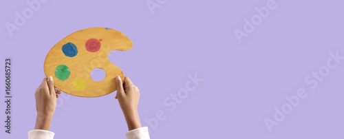 Child with paint palette on...