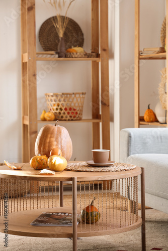 Pumpkins on table in cozy l...