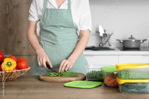 Woman cutting green beans f...