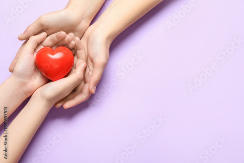 Hands of woman and child wi...