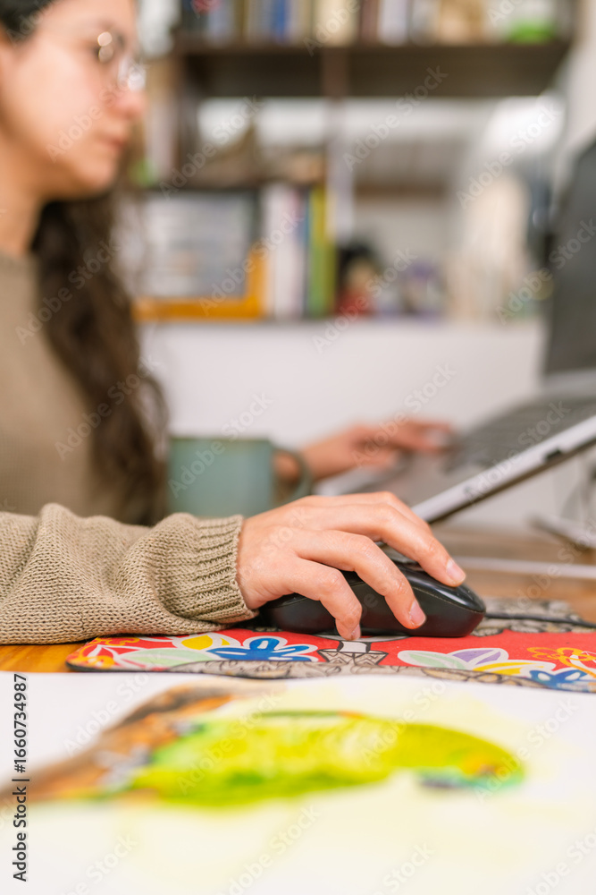 Fototapeta premium Graphic designer working from home using laptop and mouse