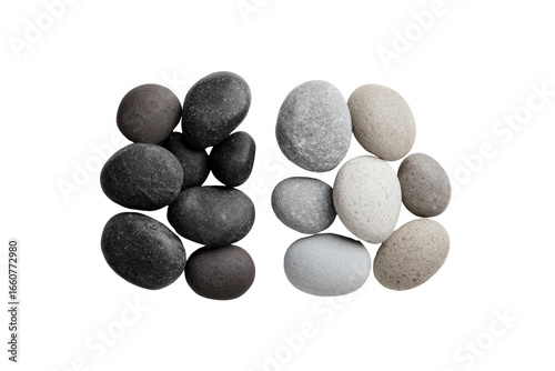 Two stacks of smooth, various-toned stones, forming an abstract shape against a black background.  The stones are dark grey, light grey, and beige