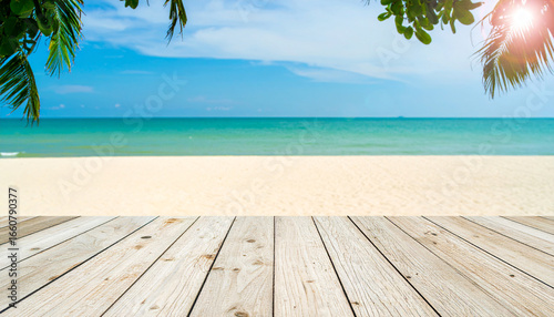Fototapeta Naklejka Na Ścianę i Meble -  Empty wooden table on a beautiful tropical beach with a wooden floor under the summer sun, overlooking the blue sea and sky horizon