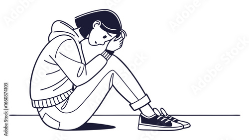 Sad young person sitting alone feeling depressed.