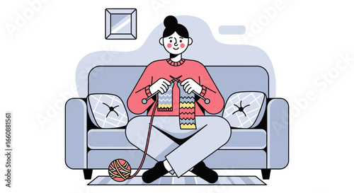 A woman sits cross-legged on a sofa, knitting with colorful yarn in a cozy, minimalist living room setting.