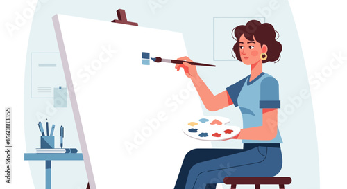 A woman artist sits painting on a blank canvas, using a paintbrush and palette.