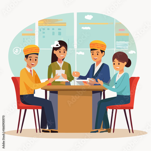 Four people collaborating around a table with documents and laptops.