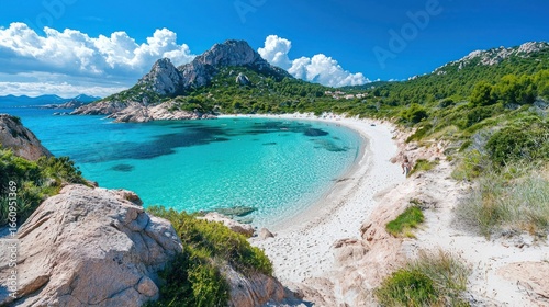 Fototapeta Naklejka Na Ścianę i Meble -  A stunning panoramic view of a pristine beach nestled within a rugged, mountainous landscape. The turquoise water gently laps against a white sand beach, framed by rocky cliffs 