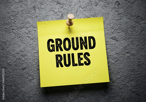 Ground rules written on a yellow post-it note pinned to a concrete wall