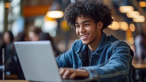 High school student playing an educational game on a laptop.