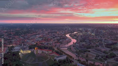 Scenic aerial view of Vilnius Old Town and Neris river at nightfall. Dramatic sunset landscape. Night view of Vilnius, Lithuania.