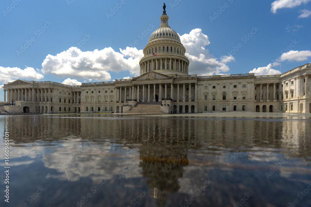 Fototapeta premium Washington DC Capitol building. Congress on Capitol Hill in Washington DC. American flag over Capitol. Washington DC landmark. Senate and House in Washington D.C..
