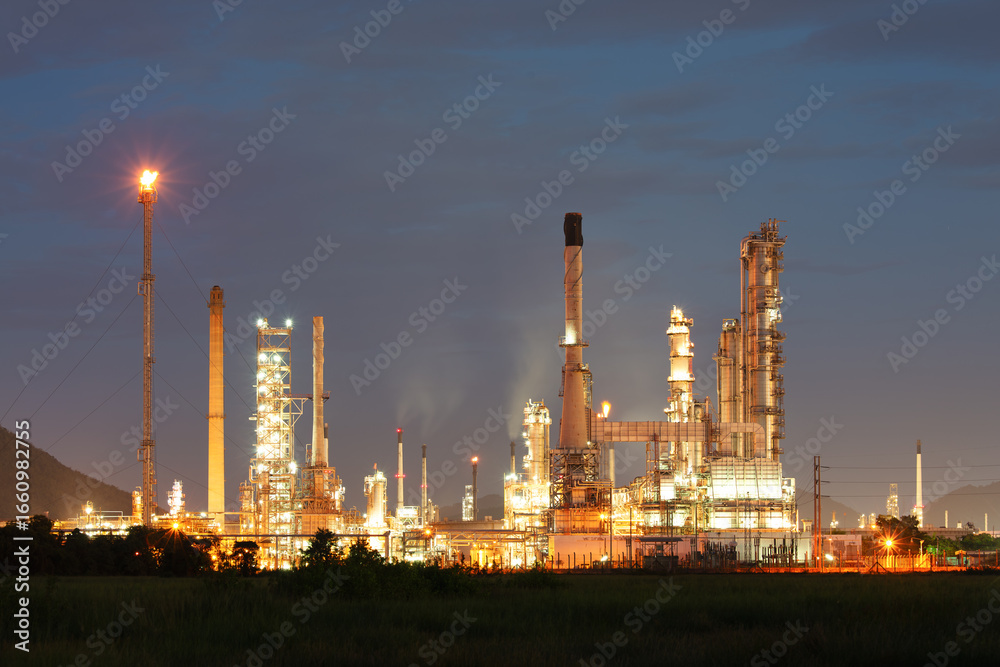 Fototapeta premium Oil gas refinery plant or petrochemical plant at night. Include gas flare or flare stack. Many machine equipment and pipeline to processing for petrol, petroleum, gasoline or fuel production.