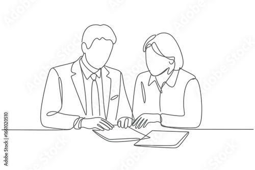 Two professionals in a meeting reviewing documents